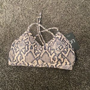 Brand New Lici fit sports bra tie in the back.